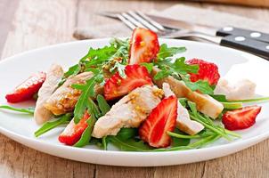 Chicken salad with arugula and strawberries photo