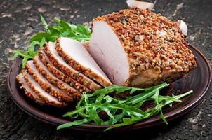 Baked pork decorated with arugula leaves photo