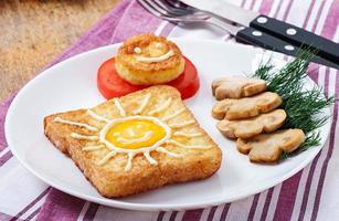 Jolly egg sandwich decorated with mushrooms and tomatoes photo