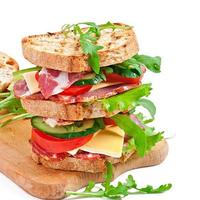 Sandwich with ham, cheese and fresh vegetables photo