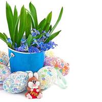 Colorful Easter eggs in a basket on a white background photo