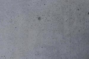 Gray concrete and dark dot on surface, gray cement background. photo
