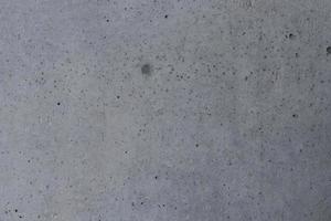 Gray concrete and dark dot on surface, gray cement background. photo