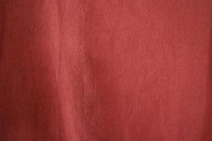 Dark red textile background, cotton fiber cloth. photo
