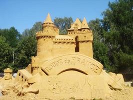 Sand castle on display in the city park. Composition of sand sculptures. photo