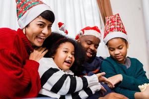 African American family have fun during video call on laptop and sitting together on the sofa photo