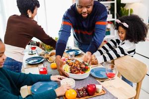 African American family. Merry Christmas. Happy family are having dinner at home. photo