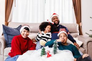 Happy family has fun sitting together on the sofa at home. cheerful young family with children laughing. African American family photo