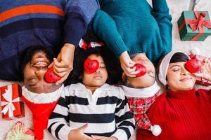 African American family in Christmas theme. Happy African American family of four bonding lying on the floor together. photo