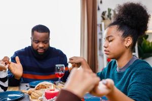 Families together to pray before meals at home. photo