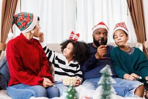 Happy family has fun sitting together on the sofa at home. cheerful young family with children laughing. African American family photo