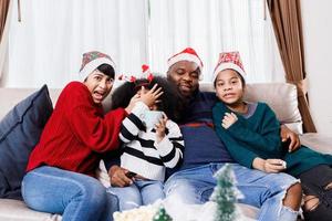 Happy family has fun sitting together on the sofa at home. cheerful young family with children laughing. African American family photo