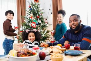 African American family. Merry Christmas. Happy family are having dinner at home. photo