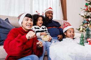 Happy family has fun sitting together on the sofa at home. cheerful young family with children laughing. African American family photo