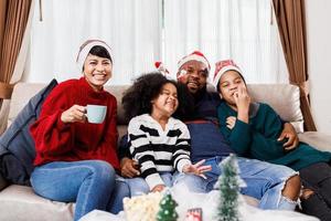 Happy family has fun sitting together on the sofa at home. cheerful young family with children laughing. African American family photo