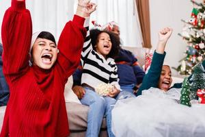 Happy family has fun sitting together on the sofa at home. cheerful young family with children laughing. African American family photo