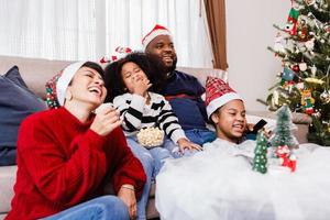 Happy family has fun sitting together on the sofa at home. cheerful young family with children laughing. African American family photo