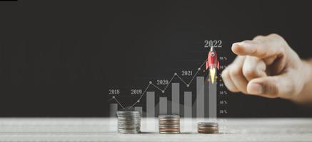 Pointing Flying Rocket Over Increasing Graph Of Coins