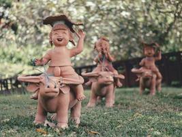 Statues of children playing in the garden . photo