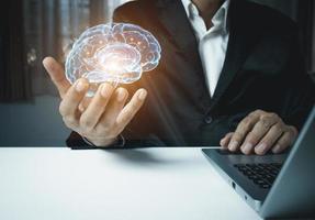 Close up of businessman holding digital image of brain photo