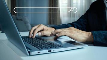 man's hands are using a computer notebook to Searching for information. photo