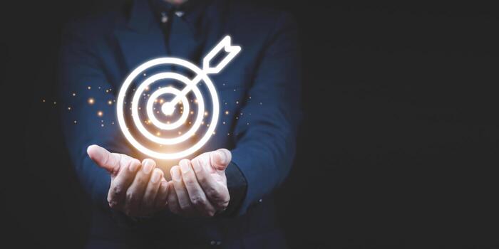 Businessman holding virtual dartboard and arrow with copy space for setup business objective target concept. photo