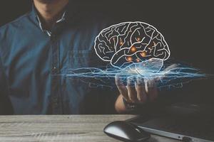 Businessman holding digital image of brain in palm photo