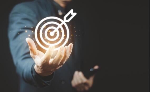 Businessman holding virtual dartboard and arrow with copy space for setup business objective target concept. photo