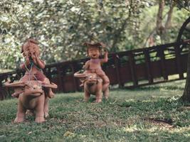 Statues of children playing in the garden . photo