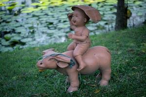 Statues of children playing in the garden . photo