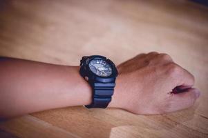 Hands and men's black wrist watches, punctuality concepts photo