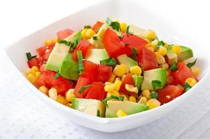 Mixed salad with avocado, tomatoes and sweet corn photo