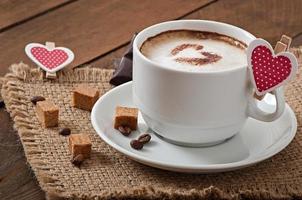 Cup of latte on the old wooden background photo