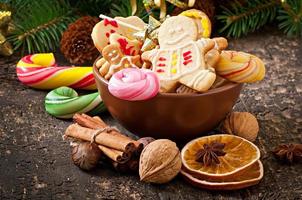 Christmas gingerbread cookies and lollipops  on old wooden background photo