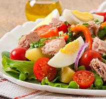 Salad with tuna, tomatoes, potato and onion photo