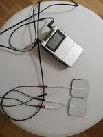 Electrical Stimulation Therapy on white chair, Electro-Acupuncture Dual channels, electric Actuator photo