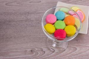 Sweet colorful macaroons on a wood background photo