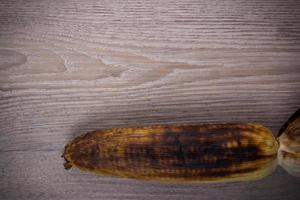 grill corn on wood background photo