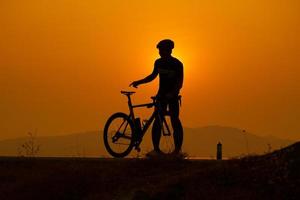 Silhouette of a cyclist on sunset in Thailand. photo