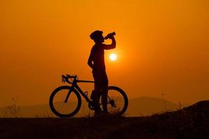 Silhouette of a cyclist on sunset in Thailand. photo