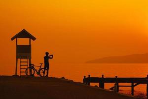Silhouette of a cyclist on sunset in Thailand. photo
