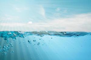 blue sea waves stopped steaming with separate bubbles on a white background. Popular corners, natural concepts photo