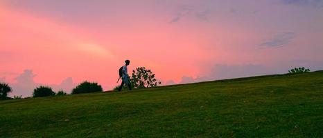 a man climbs at sunset photo