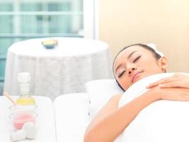 Young asian beautiful woman relaxing in spa salon photo