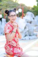 Asian beautiful woman photographed in Chinese national costumes for the Chinese New Year event photo