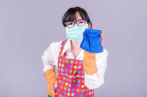Asian women must use masks to prevent dust pollution and prevent infection from viruses that spread in the air by cleaning using alcohol spray photo