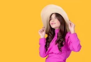 Beautiful and charming women dressed in retro style, standing in the studio holding a hat to take pictures photo