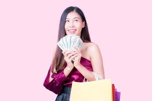 A beautiful Asian woman is happy and excited when there is a shopping motive to buy the products photo