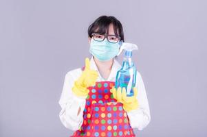 Asian women must use masks to prevent dust pollution and prevent infection from viruses that spread in the air by cleaning using alcohol spray photo
