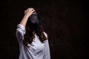 Stressed Asian women must use a gas mask to prevent dust pollution and prevent infection from viruses that spread in the air photo